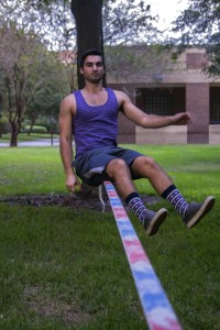 Matt Morin balancing on the slackline and preparing to work on some jump tricks. Photo by Chelsea Santiago.