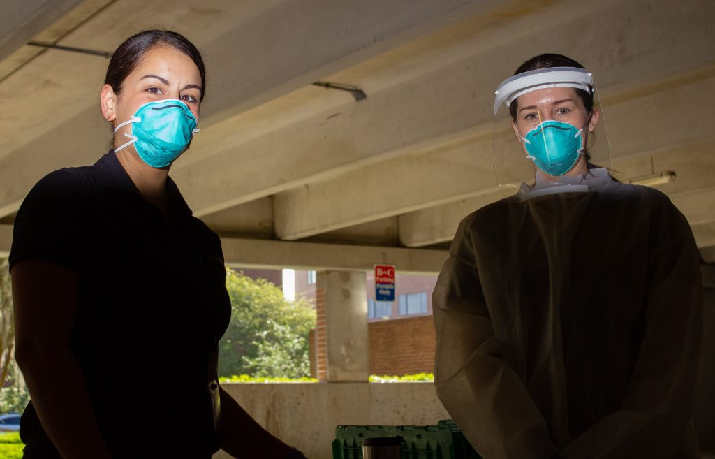 Aventus Biolab healthcare workers wear personal protective equipment at UCF's COVID-19 testing site on Monday. Photo by Dylan Clayton. 